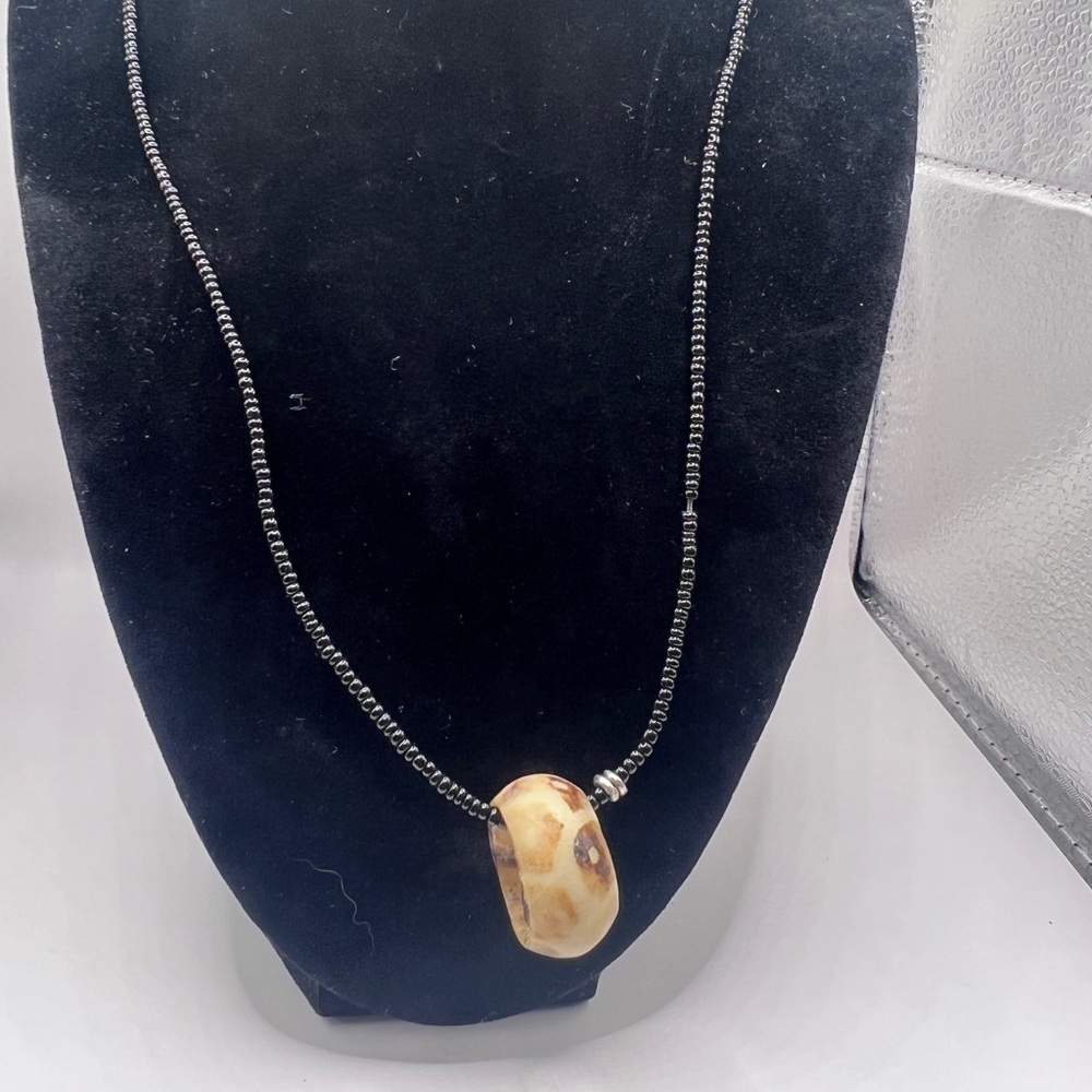 Carved shell circle pendant necklace with black seed pearls